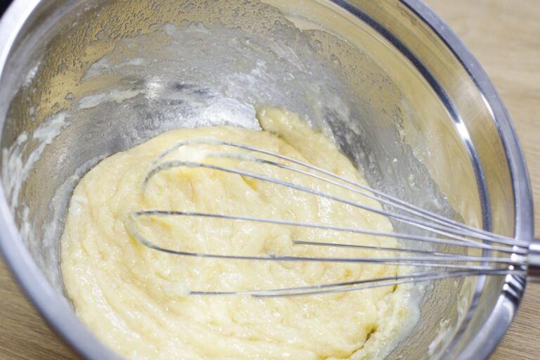 Leftover Cake Batter in a Large Metal Bowl With Whisk