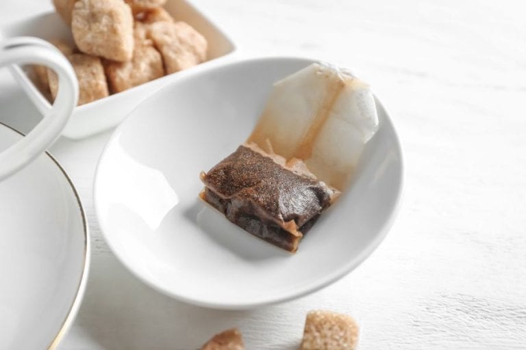Used tea bag sitting on a plate