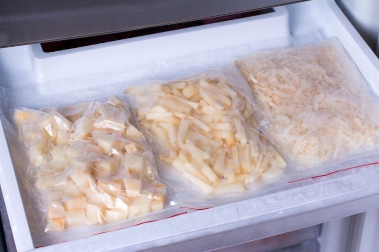 Frozen potatoes in bags in the freezer