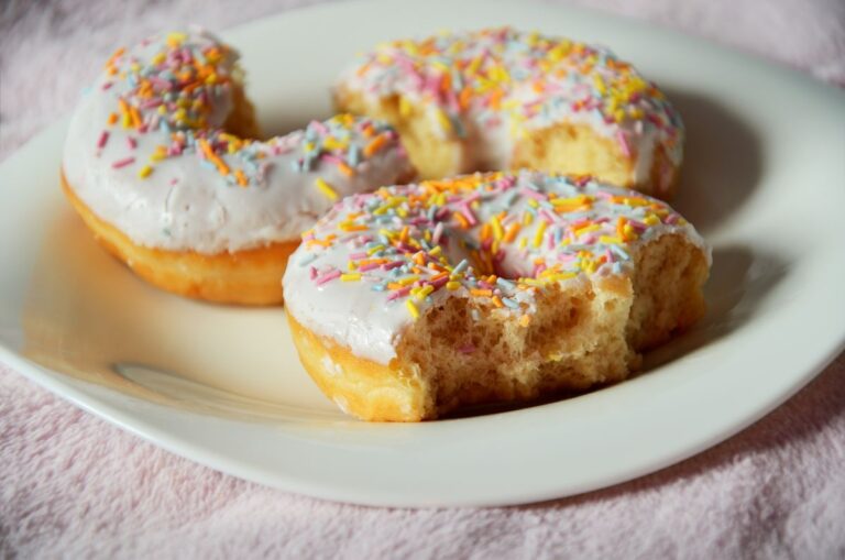 Half-Eaten Leftover Donuts on a Small Plate