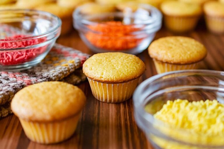 Three Mini Cupcakes With Bowls of Sprinkles
