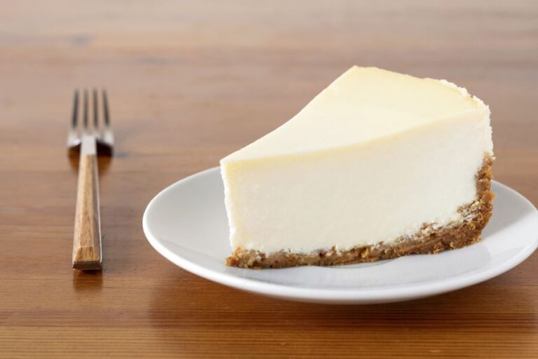 Slice of Plain New York Cheesecake on Wooden Table