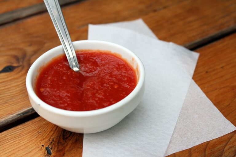 A Small Ceramic Dish with Pizza Sauce