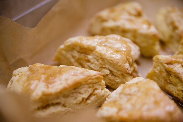 Freshly Glazed Lemon Scones on Parchment Paper