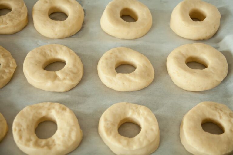 Raw Donuts on Baking Paper and Tray