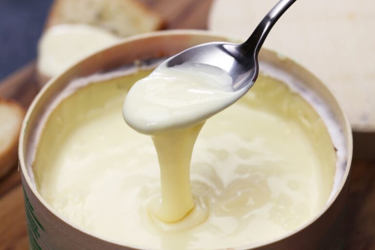Scooping Out Melted Cheese with a Spoon