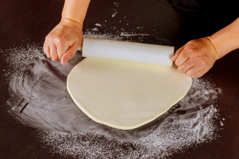 Baker Rolling Out Fondant on Counter
