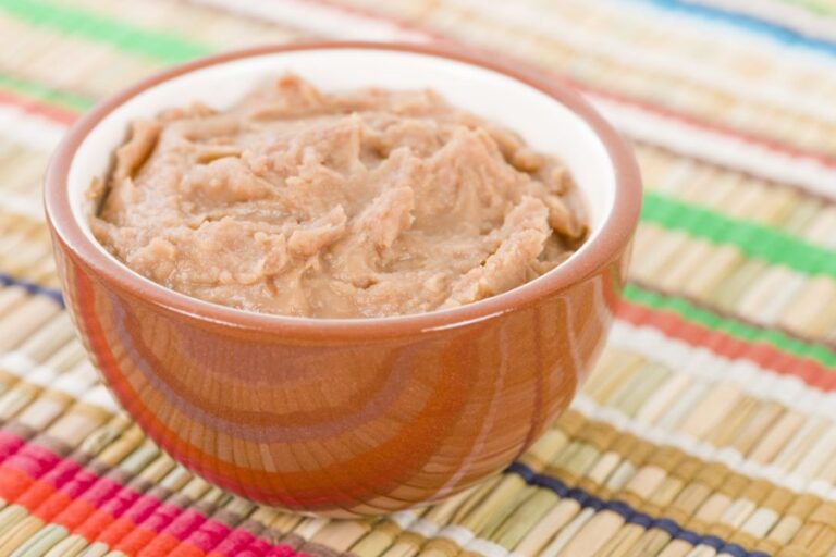 Bowl of Thick Refried Beans in Brown Bowl