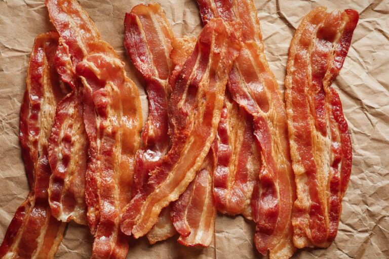 Cooked Bacon Slices on Parchment Paper