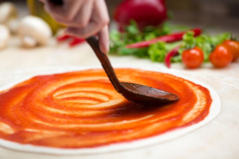 Spreading Sauce on a Pizza