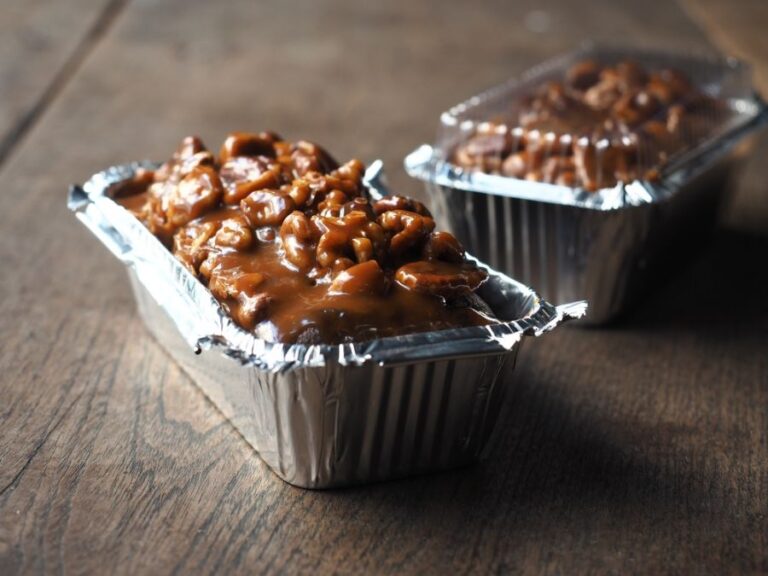 Chocolate Cake in a Foil Pan Covered With Toffee Sauce With Pecans and Walnuts