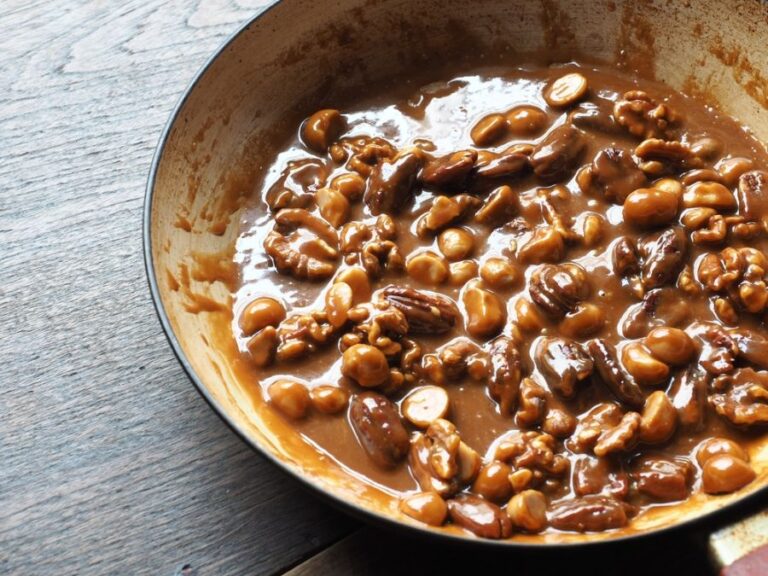 Toffee Sauce Cooking in a Pan With Pecans and Walnuts