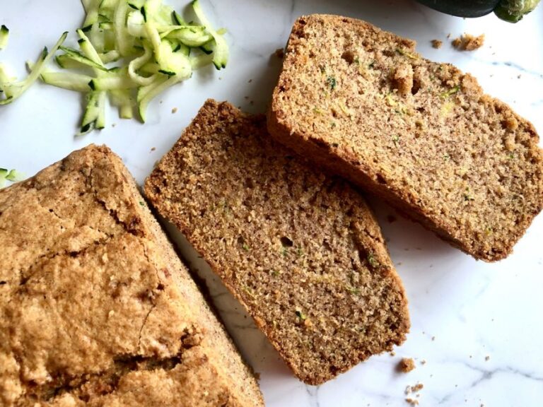 Fresh Sliced Zucchini Bread With Shredded Zucchini in Background