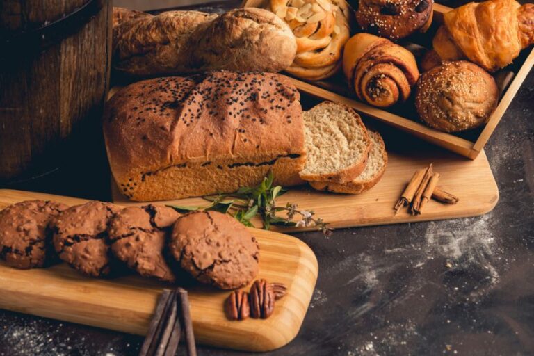 Homemade Bread and Cookies on Cutting Boards on a Black Table
