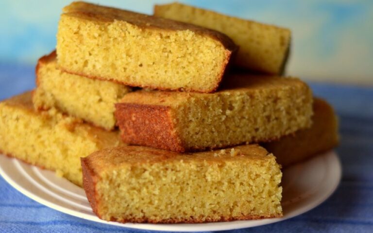 Dense Squares of Cornbread on a White Plate