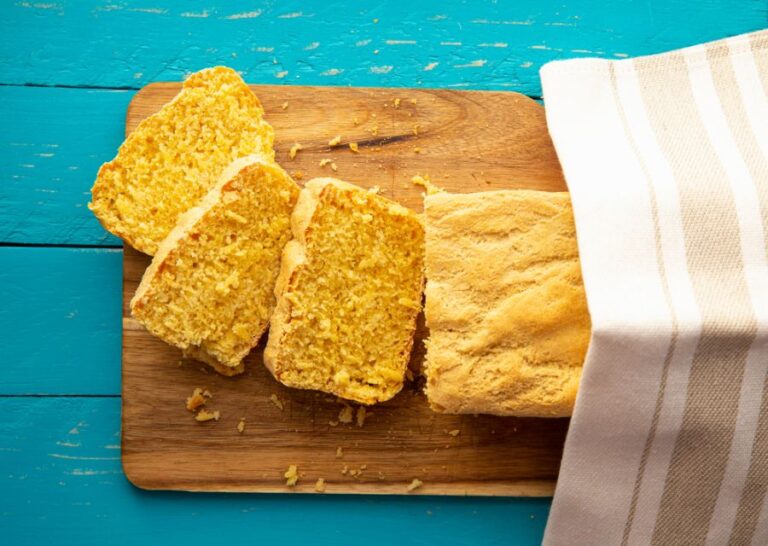 Fresh Loaf of Cornbread Cut Up on a Cutting Board