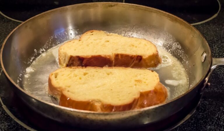 Two Pieces of French Toast in a Frying Pan With Butter