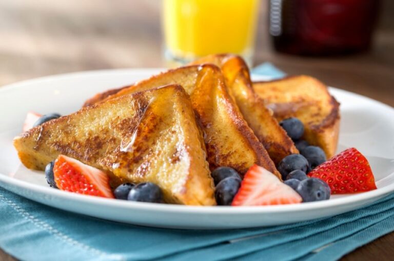 Breakfast With French Toast, Syrup, and Berries on a White Plate