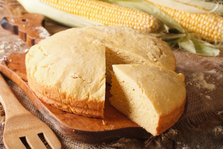 Round Loaf of Cornbread Cut on a Cutting Board