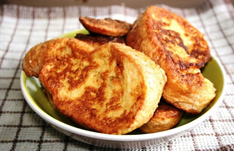 Several Pieces of French Toast Served on a Green Plate