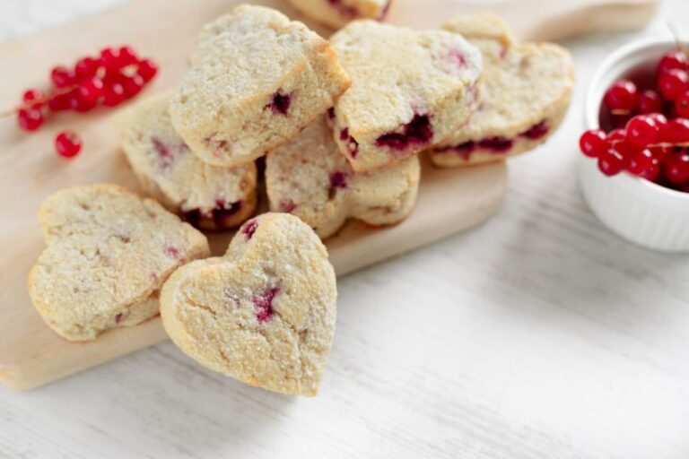 Heart-Shaped Red Currant Scones on a Wooden Cutting Board