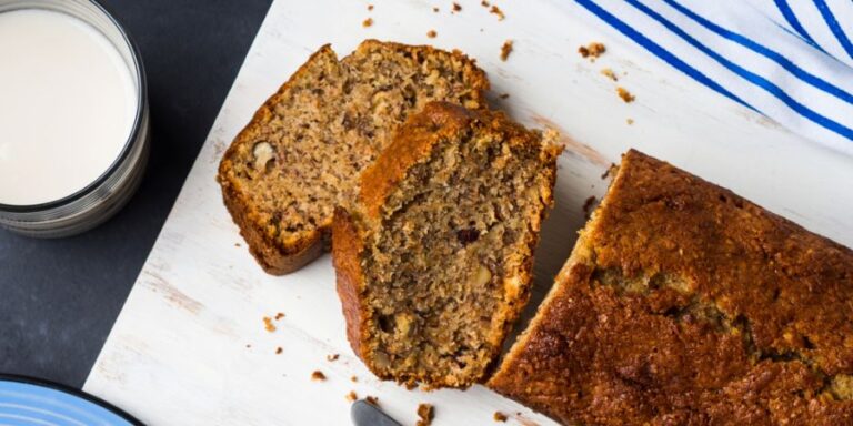 Loaf of Banana Bread Cut up on a Cutting Board