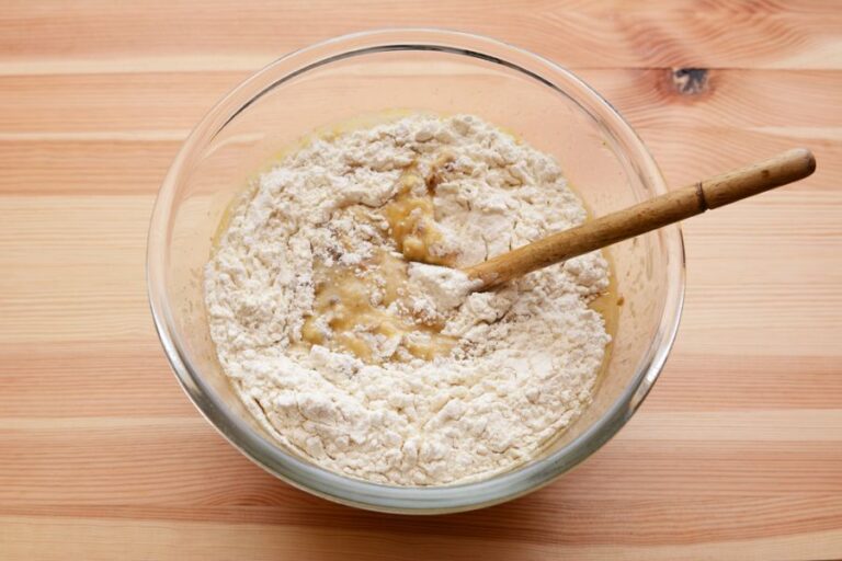 Flour Being Stirred Into Wet Ingredients for Banana Bread