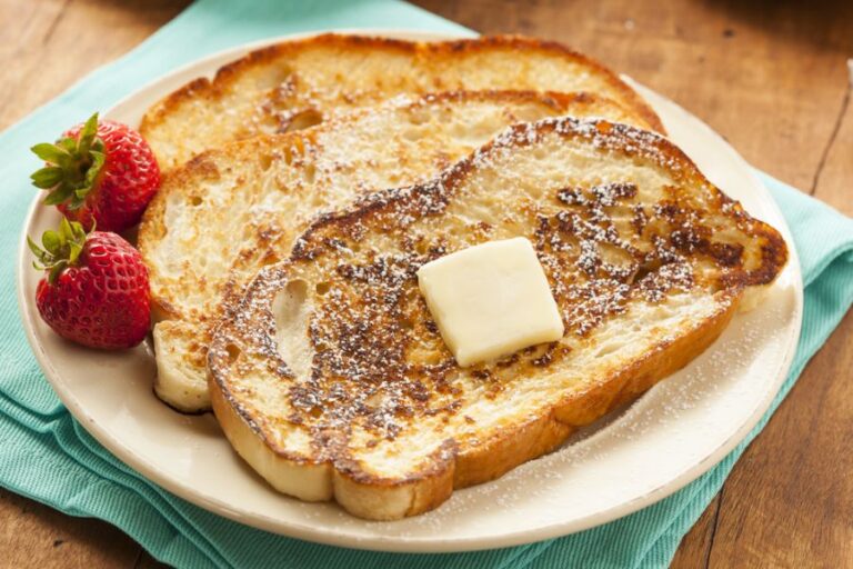 Homemade French Toast With a Pat of Butter and Powdered Sugar