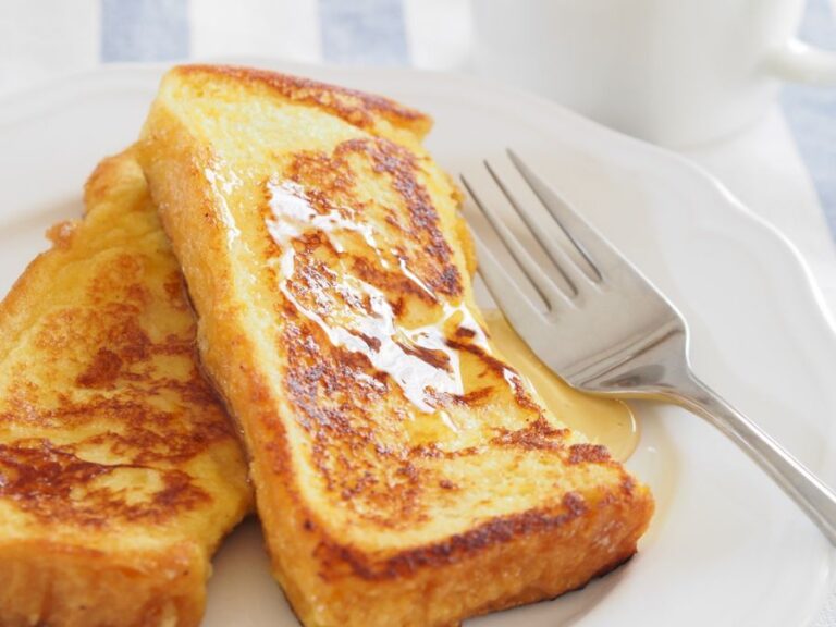 French Toast Halves With Syrup on a White Plate