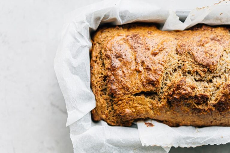 Closeup of a Loaf of Banana Bread in a Pan With Parchment Paper