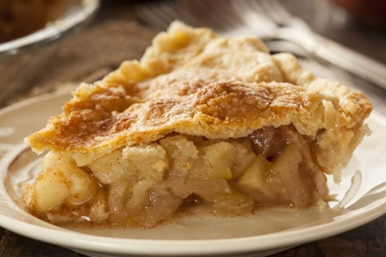 Slice of a Homemade Apple Pie on a White Plate
