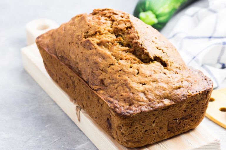 Freshly Baked Loaf of Zucchini Bread on a Wooden Cutting Board