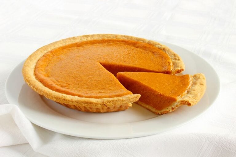 Sliced Pumpkin Pie on a White Plate