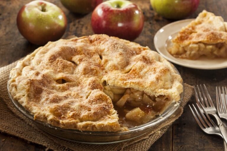 Freshly Baked Apple Pie With a Slice on a Plate