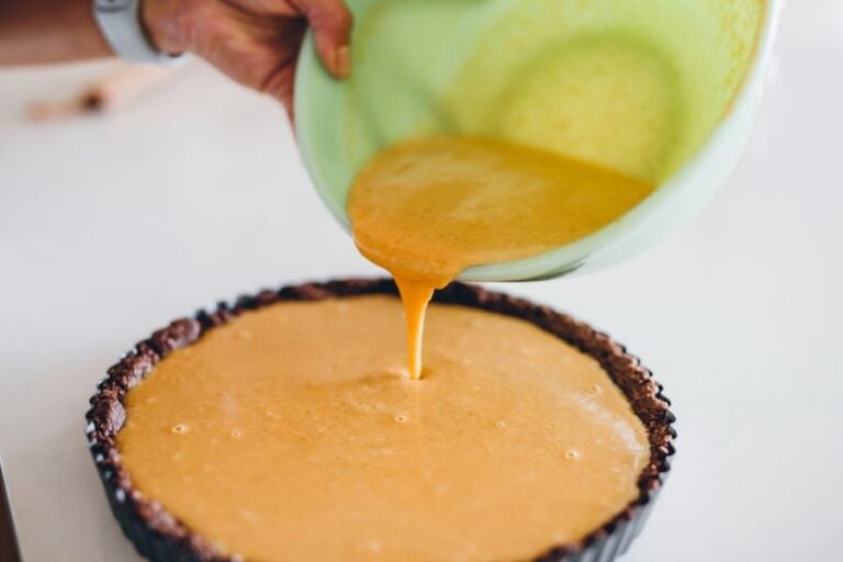 Pouring Pumpkin Pie Filling Into a Crust