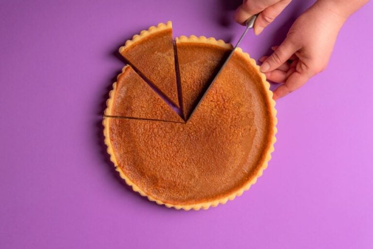Pumpkin Pie Being Cut on a Purple Background