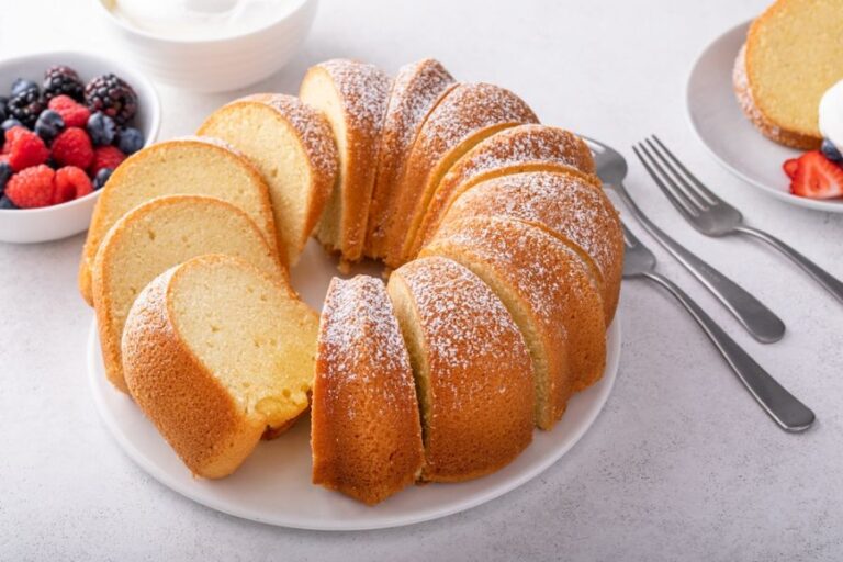 Bundt Cake Sliced and Served With Berries and Cream