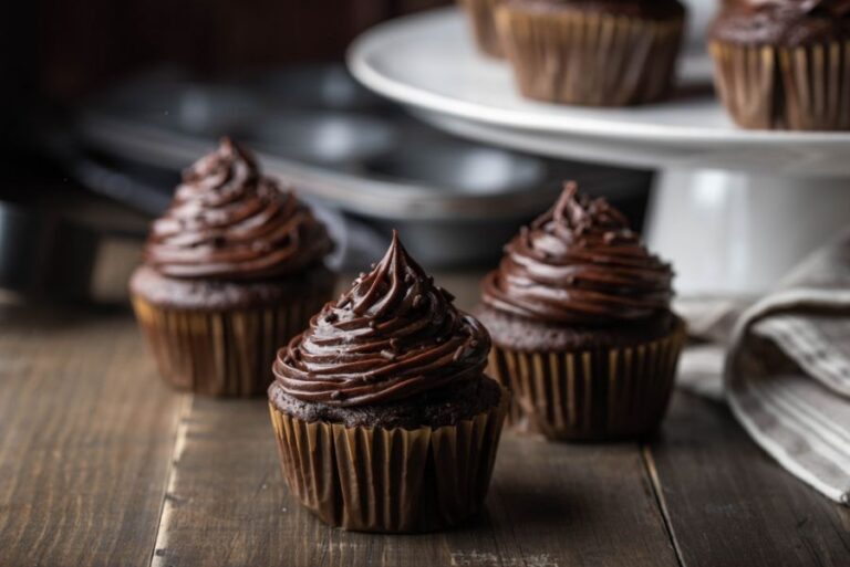 Chocolate Cupcakes With Chocolate Frosting on a Wooden Table