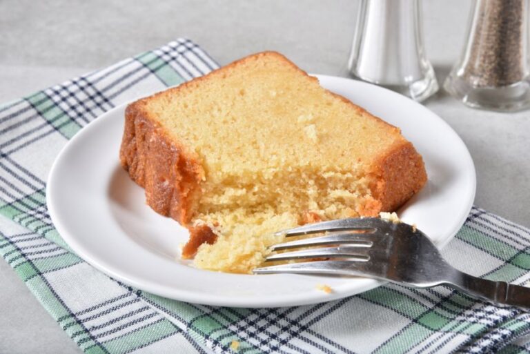 Piece of Pound Cake on a White Plate With a Fork