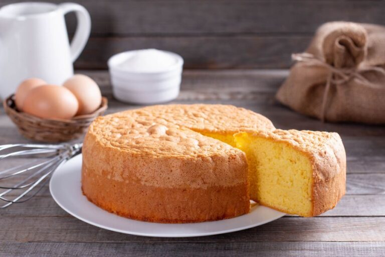 Slice of Pound Cake Taken From Cake With Ingredients in the Background