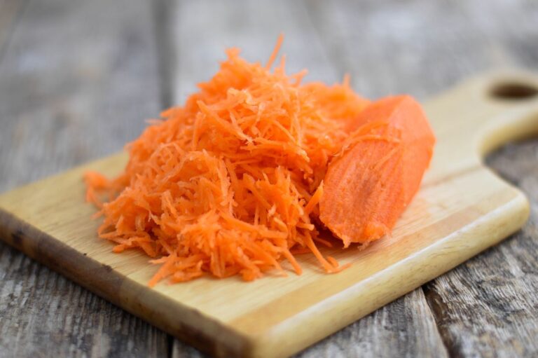 Grated Carrots on a Cutting Board