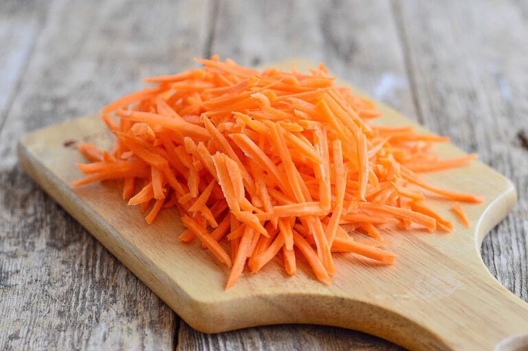 Shredded Carrots on a Cutting Board