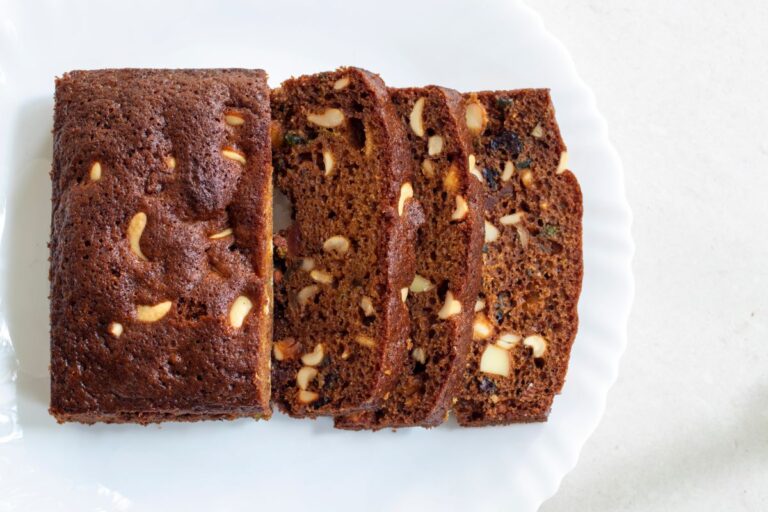 Plum Cake Sliced on a White Plate