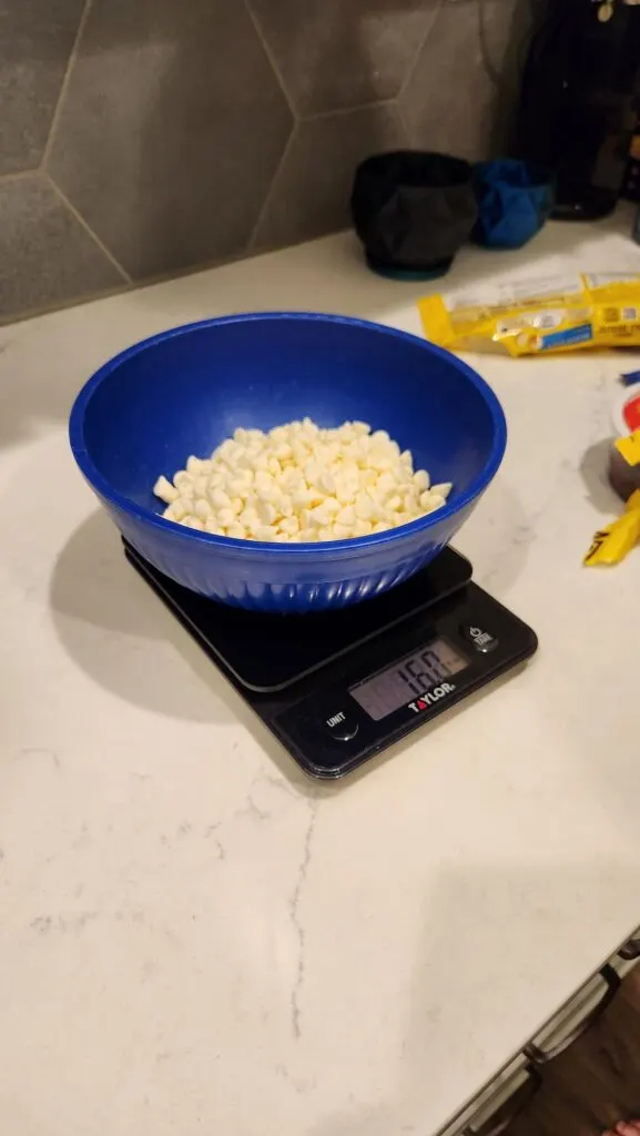 Bowl of White Chocolate Chips on the Scale