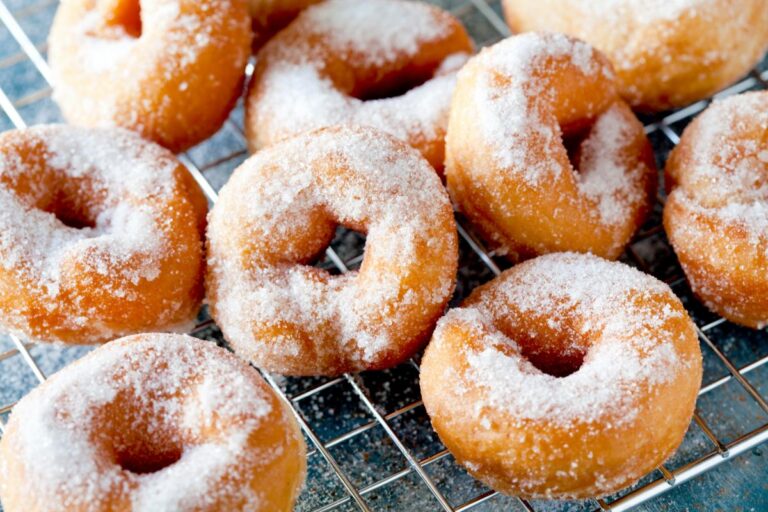 Fresh Baked Sugar Covered Donuts on a Mesh Cooling Rack